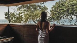A person standing by a window with a view of trees and a body of water. - Falkensteiner Hotel & Spa Iadera (Zadar)