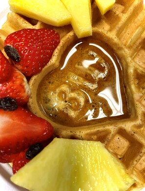 A waffle with fruit and syrup. - Best Western Plus Lacey Inn & Suites (Olympia)