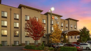A hotel with a sign reading "Best Western PLUS" and a parking lot with several cars. - Best Western Plus Lacey Inn & Suites (Olympia)