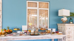 A breakfast buffet with various food items and a decorative lamp. - Bleu de Toi - Boutique Guest House (Grand-Baie)