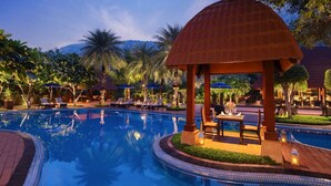 A pool area with lounge chairs and a gazebo. - Ananta Spa and Resorts (Pushkar)