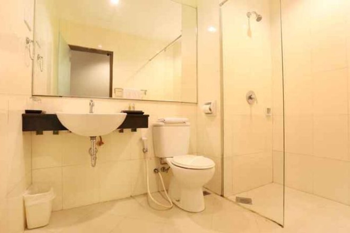 A bathroom with a sink, toilet, and shower.