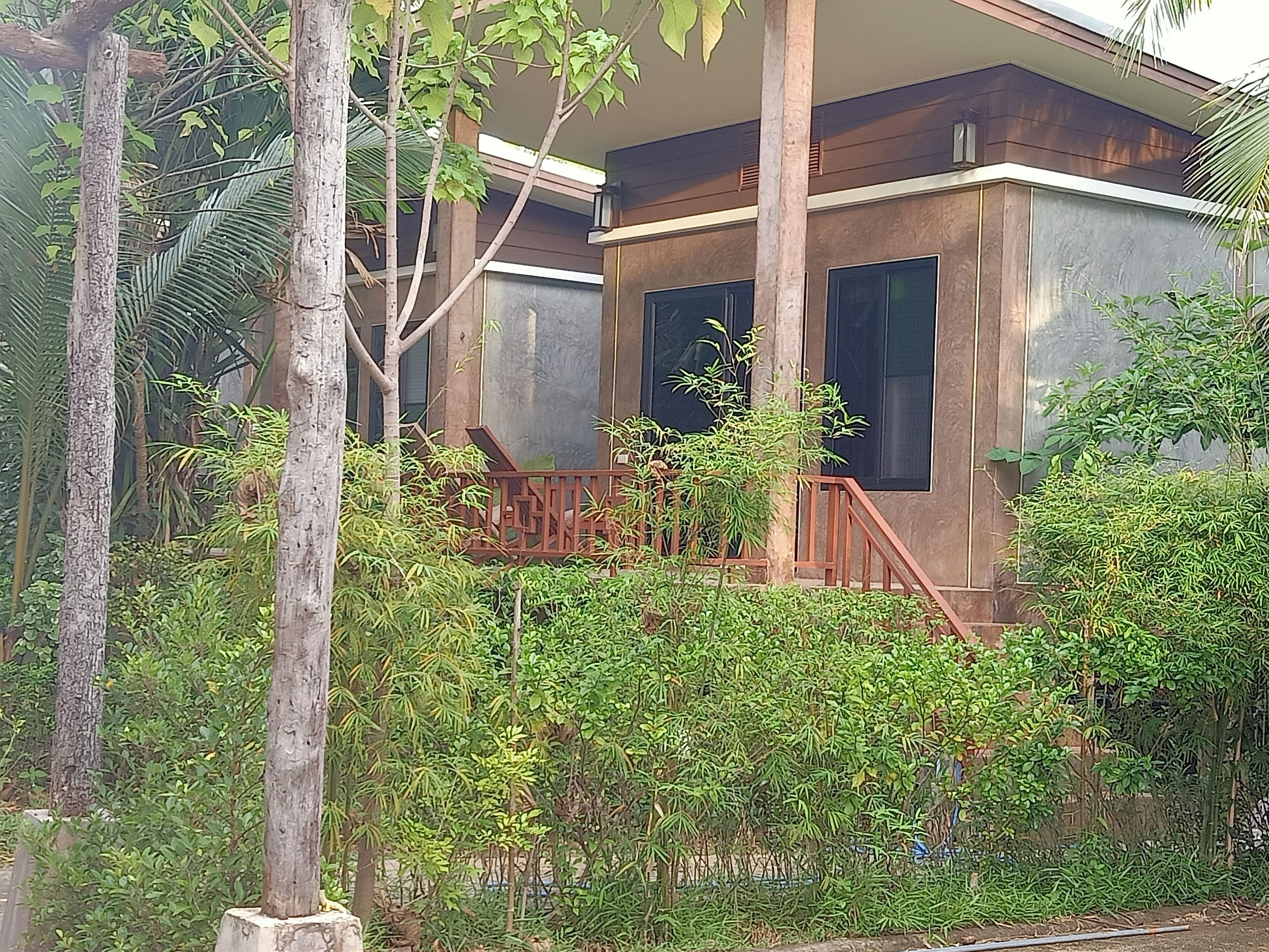 A modern house with a wooden deck and a large window.