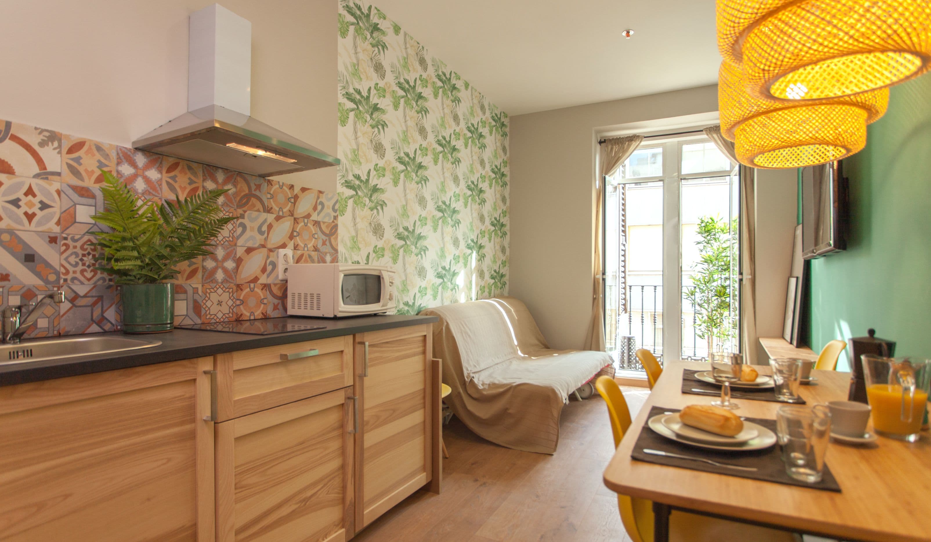 A modern kitchen with a microwave, sink, and wooden cabinets.