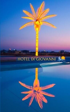 A hotel sign with a palm tree design, indicating a tropical theme.
