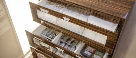 A wooden storage unit with multiple compartments, each labeled with different categories.