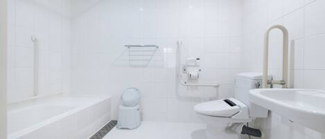 A modern bathroom with a bathtub, toilet, and sink.