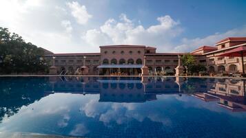 A large building with a reflective pool in front.