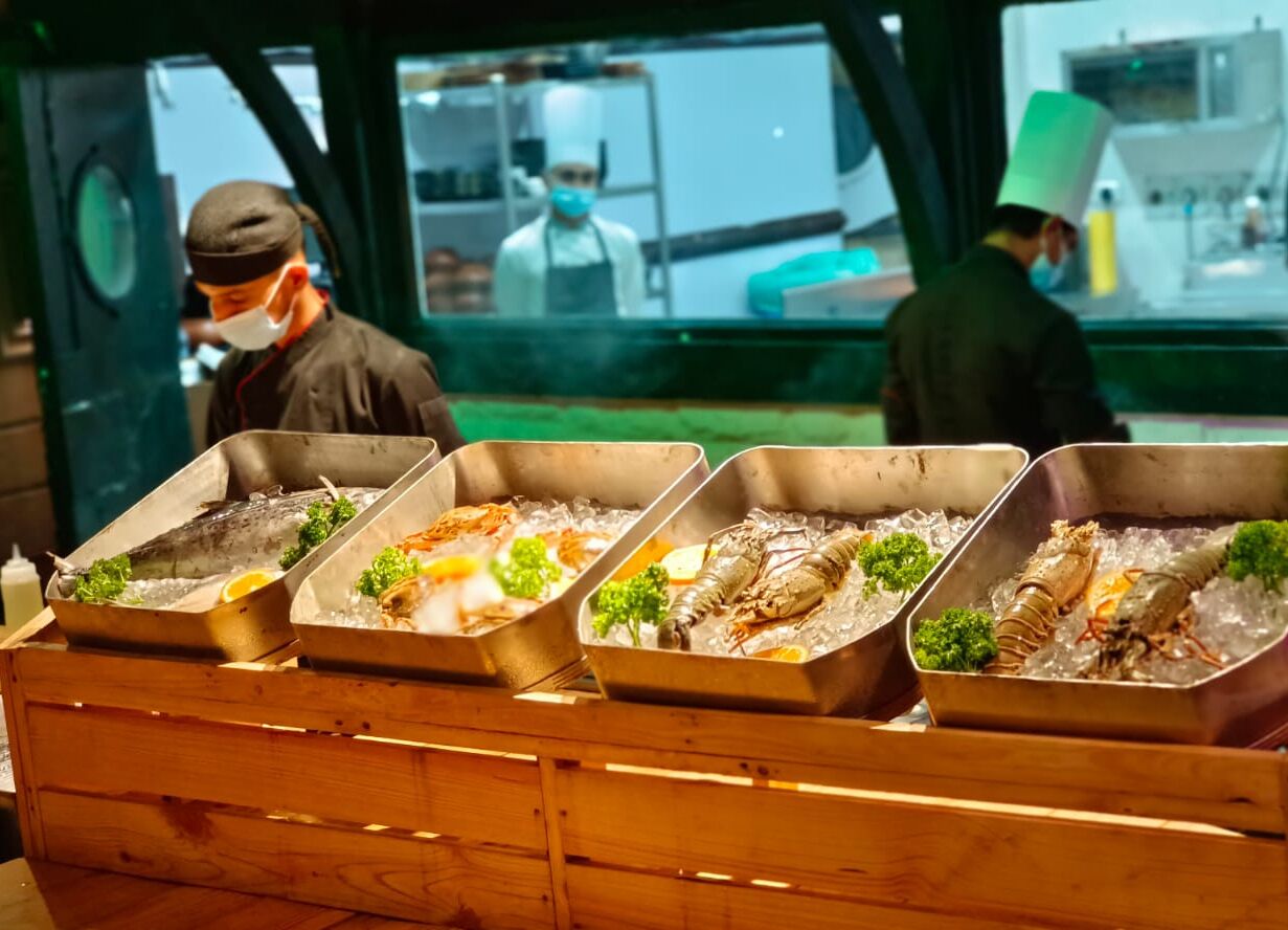 Un bufé con mariscos dispuestos en bandejas.