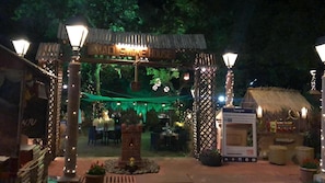 A restaurant entrance with a sign reading "MAD SMOKE HOUSE" and a thatched-roof structure to the right. - Evershine Resort & Spa (Mahabaleshwar)