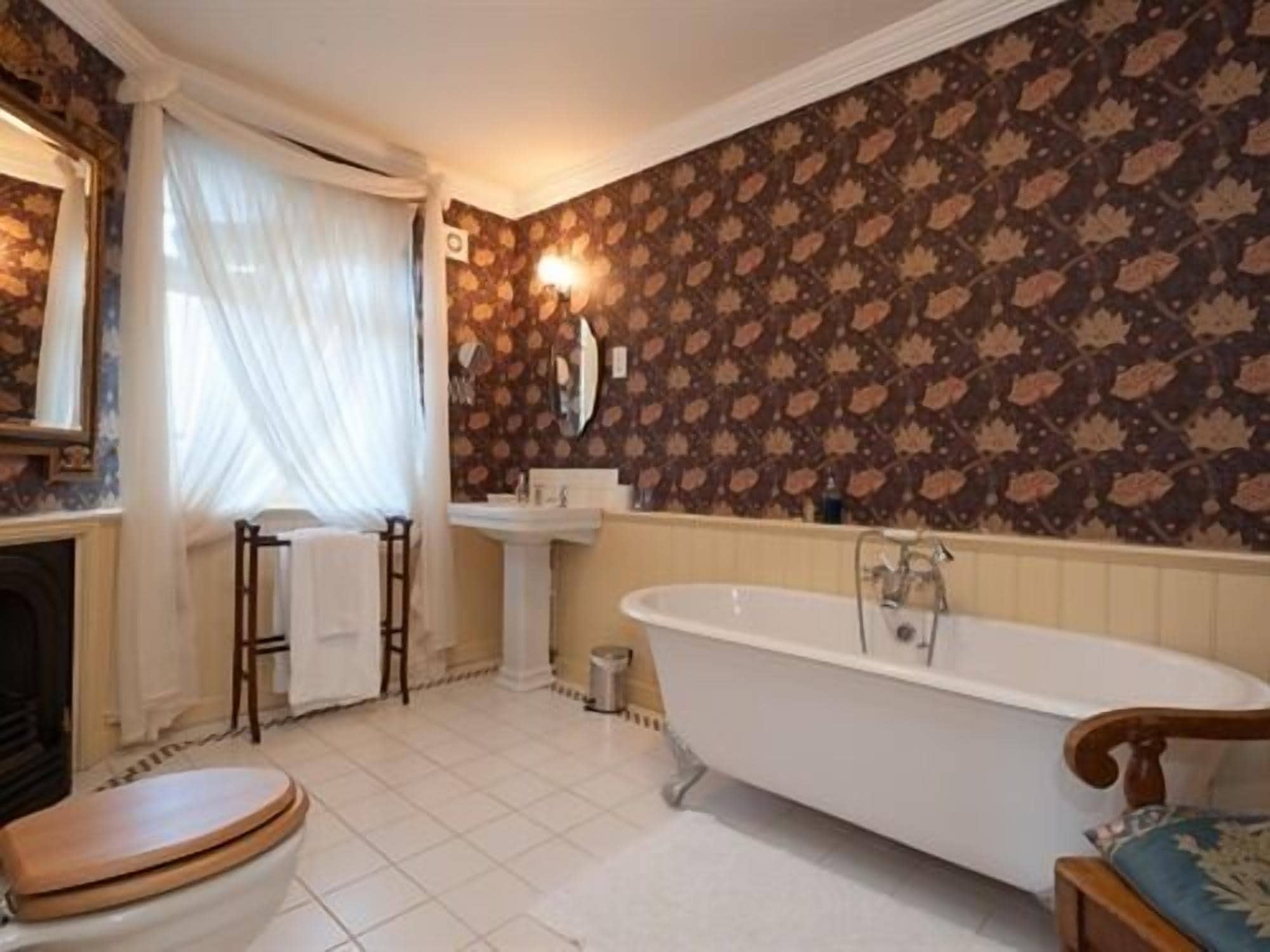 A bathroom with a freestanding bathtub, a sink, and a toilet.