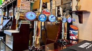 A bar with multiple beer taps, including brands like Carling and Guinness. - The Brunswick Hotel (Bridlington)