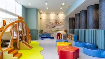 Kids can play and relax in a vibrant space with a slide, playhouse, and cozy seating areas.