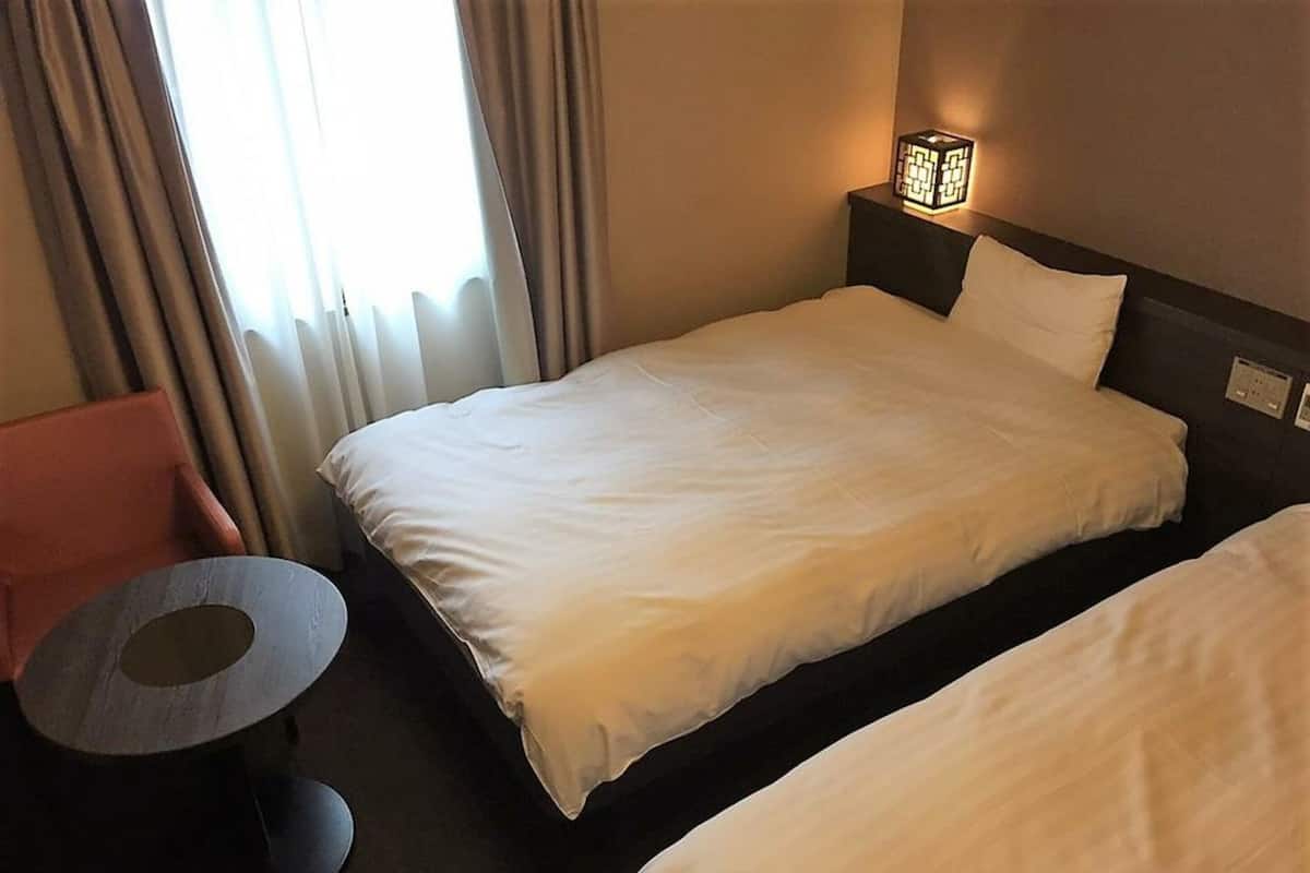 Premium bedding, down comforters, blackout drapes, iron/ironing board