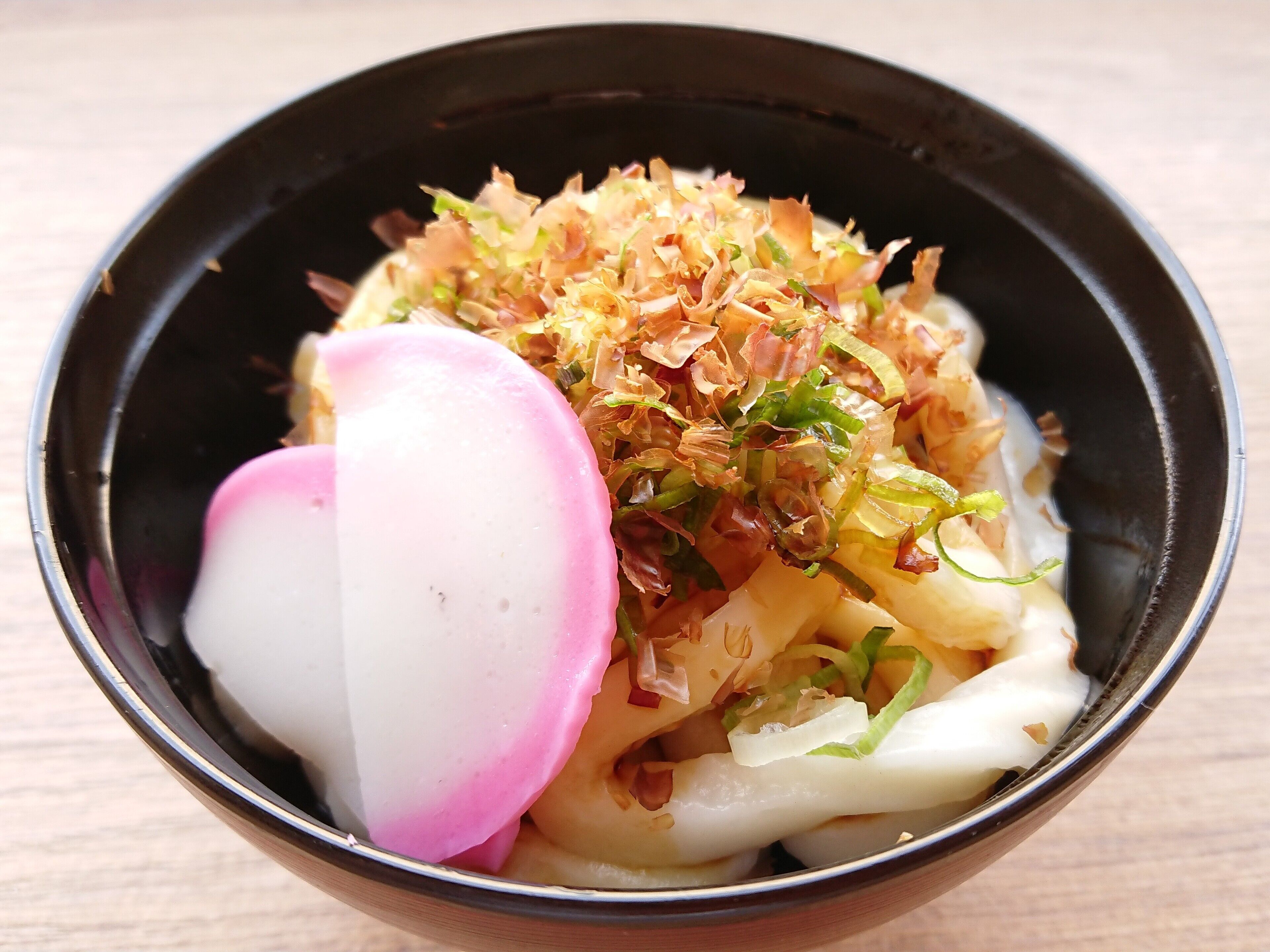 A bowl of food with various toppings.