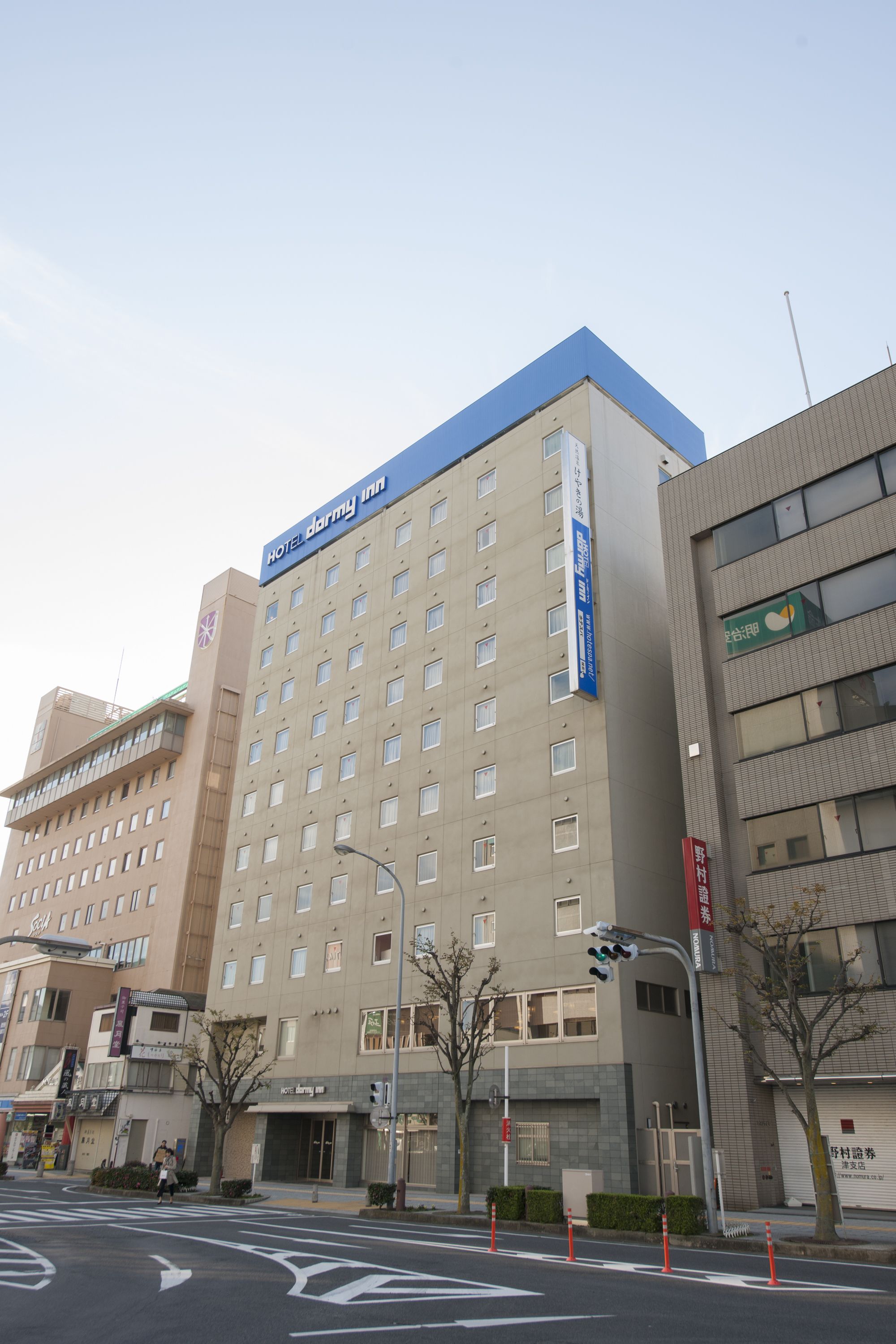 A multi-story hotel with a prominent blue sign on the top.