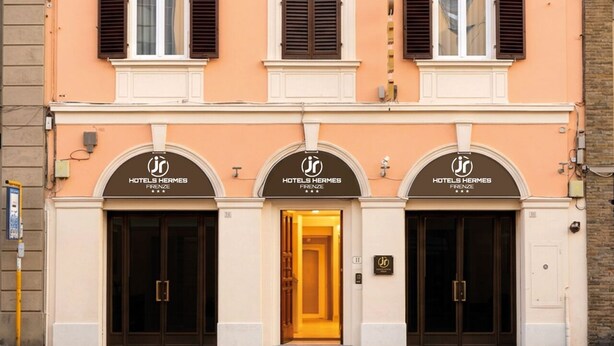 A hotel facade with three entrances, each marked with the hotel's logo and name. - JR Hotels Hermes Firenze (Florence)