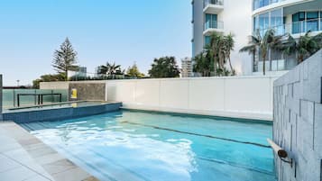Relax by the rectangular pool surrounded by a tiled deck and enjoy the serene atmosphere.