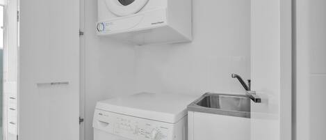 A compact, modern laundry room with a Bosch washing machine and a sink.