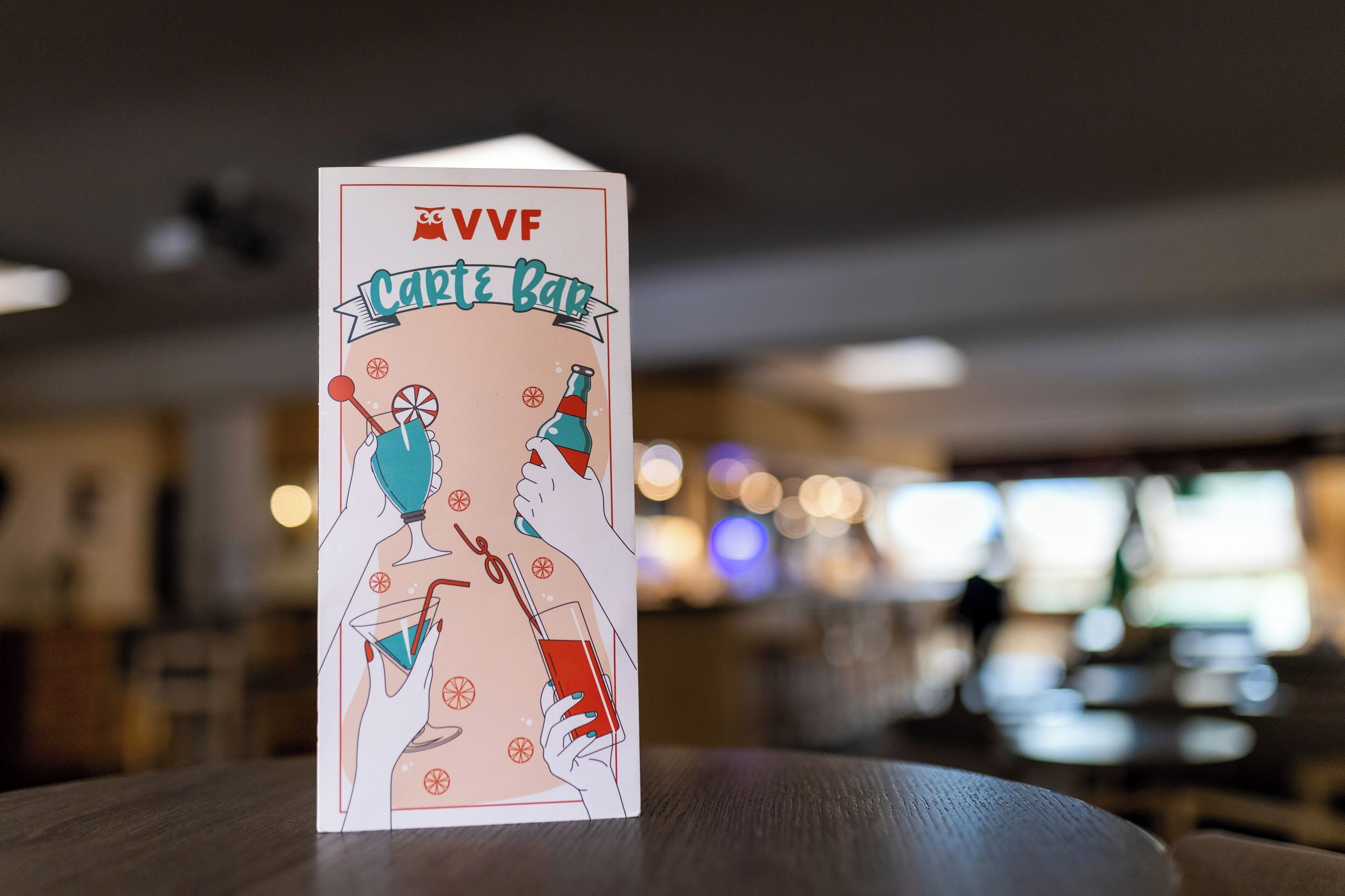 A card with a bar theme, featuring illustrations of people holding drinks and bar accessories.