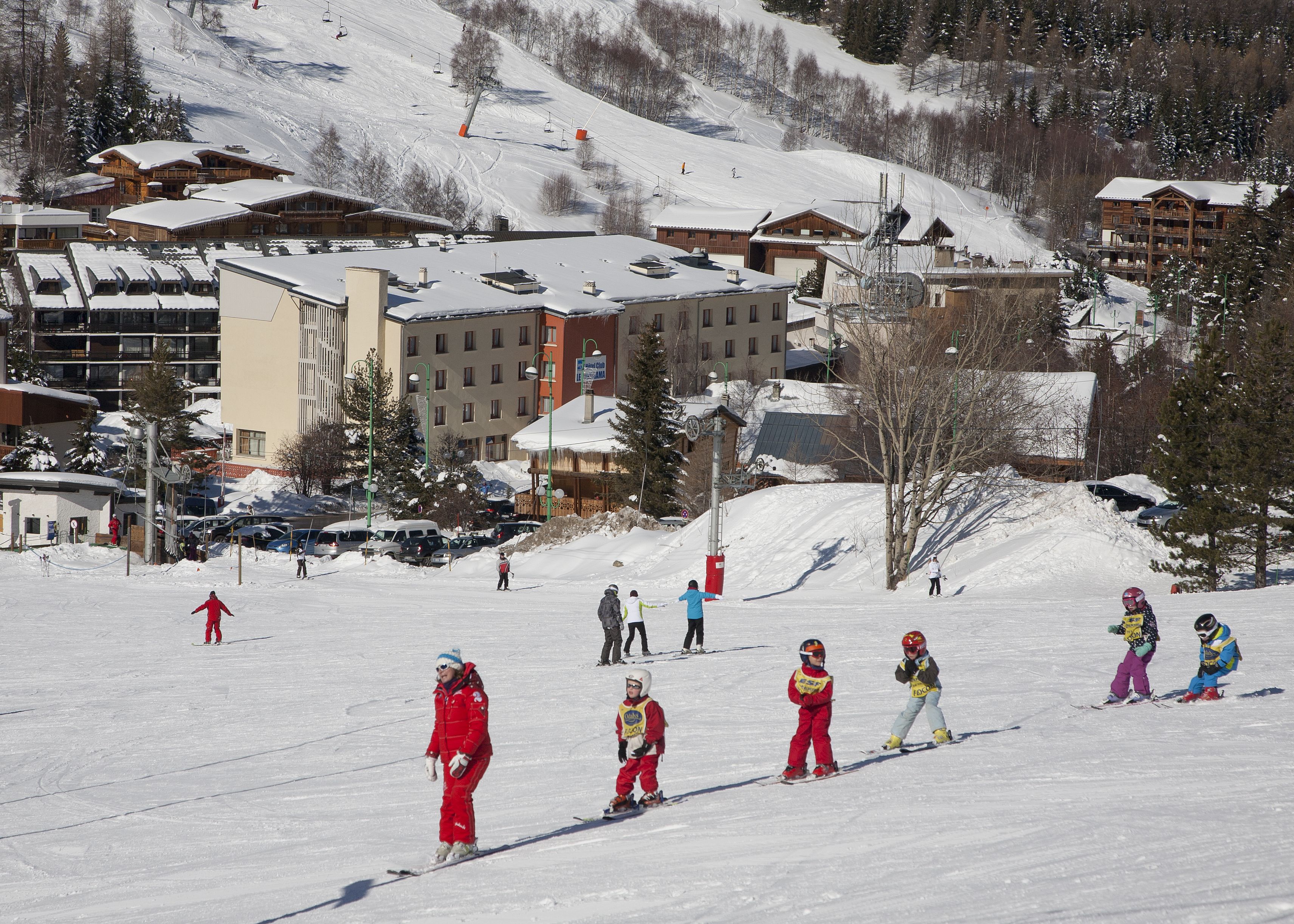 A ski resort with multiple buildings, including lodges and a ski lift.
