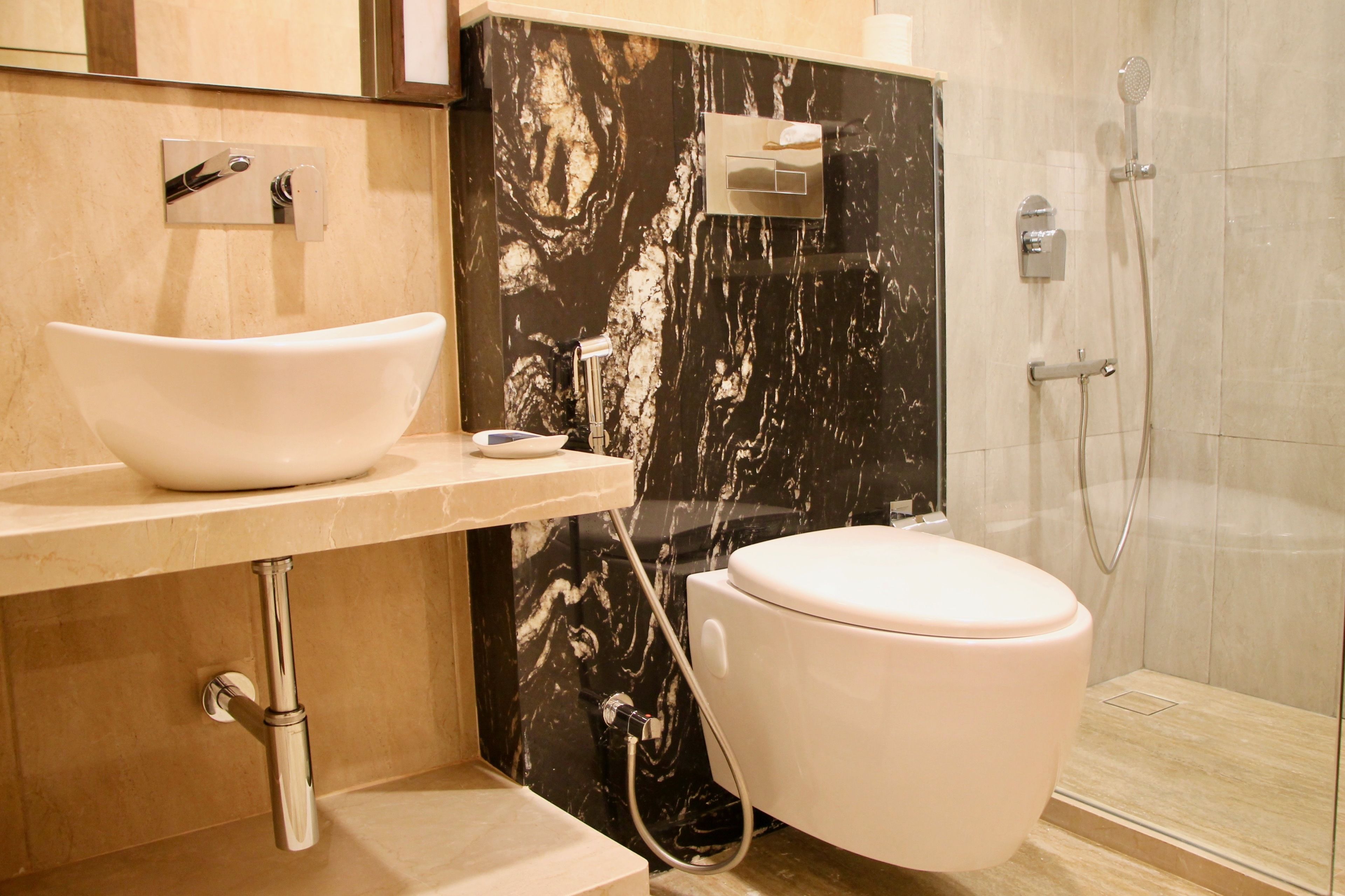 A bathroom with a white sink, a toilet, and a shower.