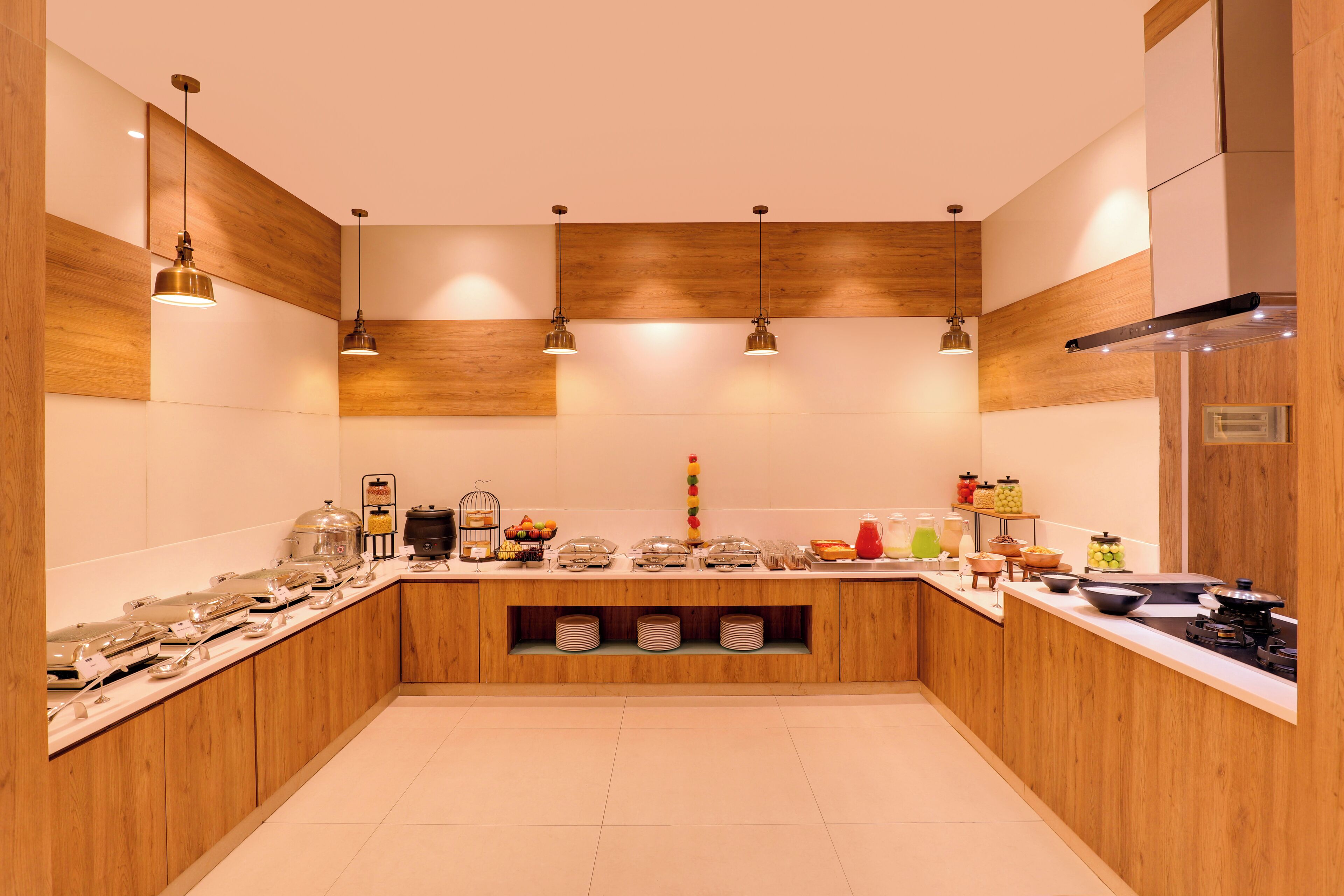 A modern kitchen with wooden cabinetry, a central island with a sink, and overhead pendant lighting.