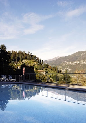 Outdoor pool, open 9:00 AM to 8:00 PM, pool umbrellas, pool loungers