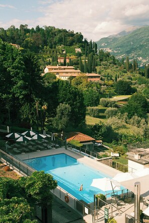 Outdoor pool, open 9:00 AM to 8:00 PM, pool umbrellas, pool loungers