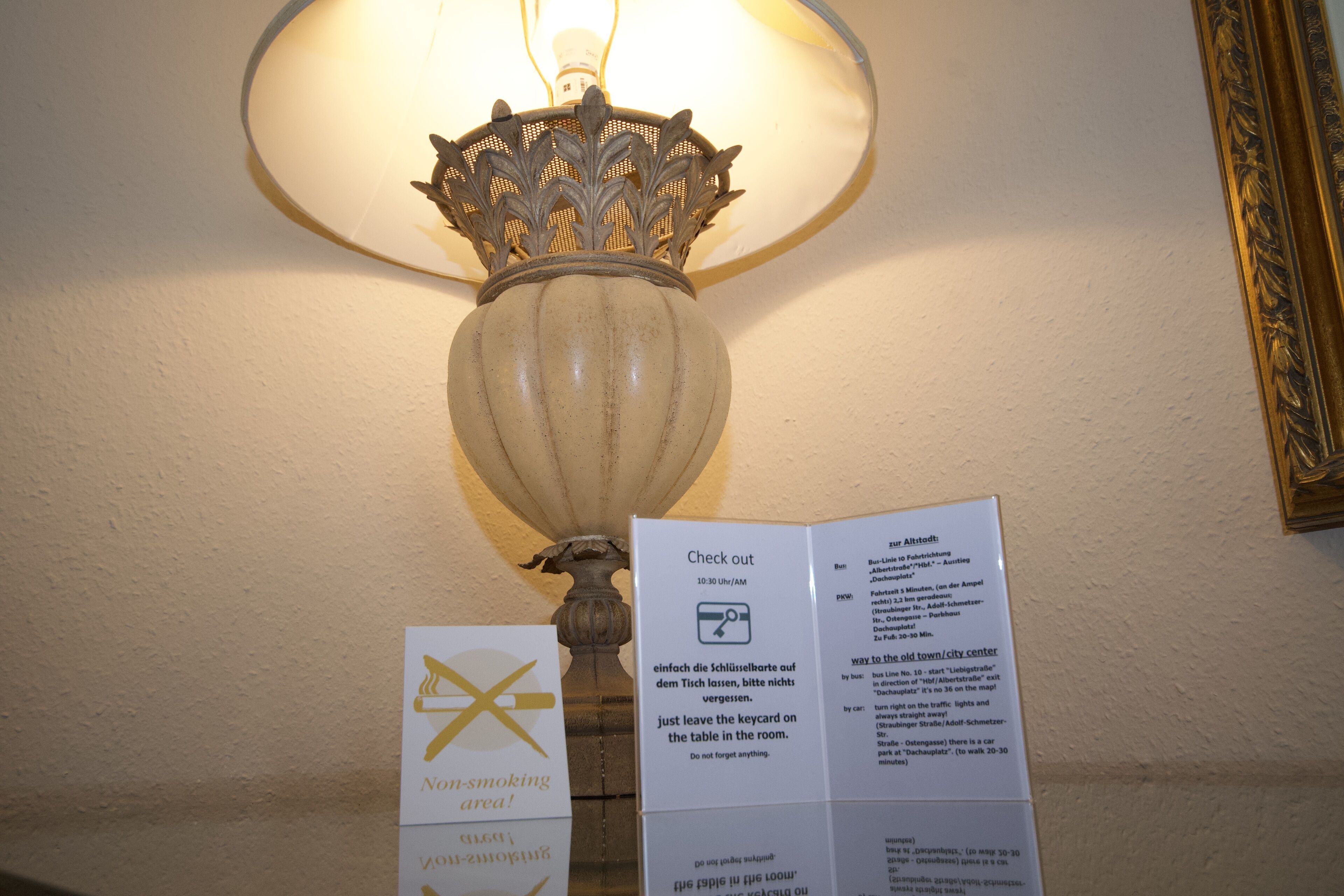 Un panneau indiquant qu'il est interdit de fumer, une lampe et un panneau indiquant les heures de départ et les instructions.