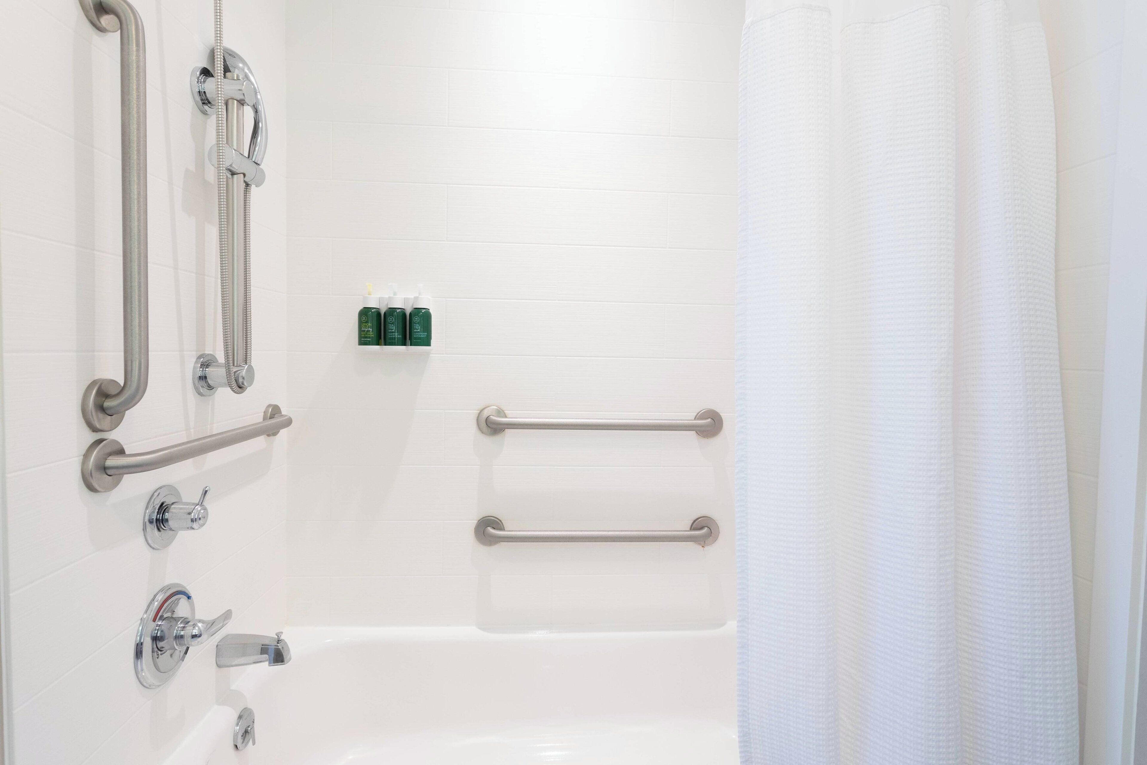 suite, multiple beds | bathroom | hydromassage showerhead, free toiletries, hair dryer, towels