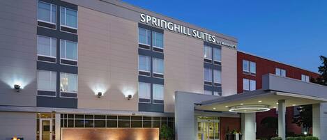 A modern hotel with a prominent sign reading "SPRINGHILL SUITES BY MARRIOTT".