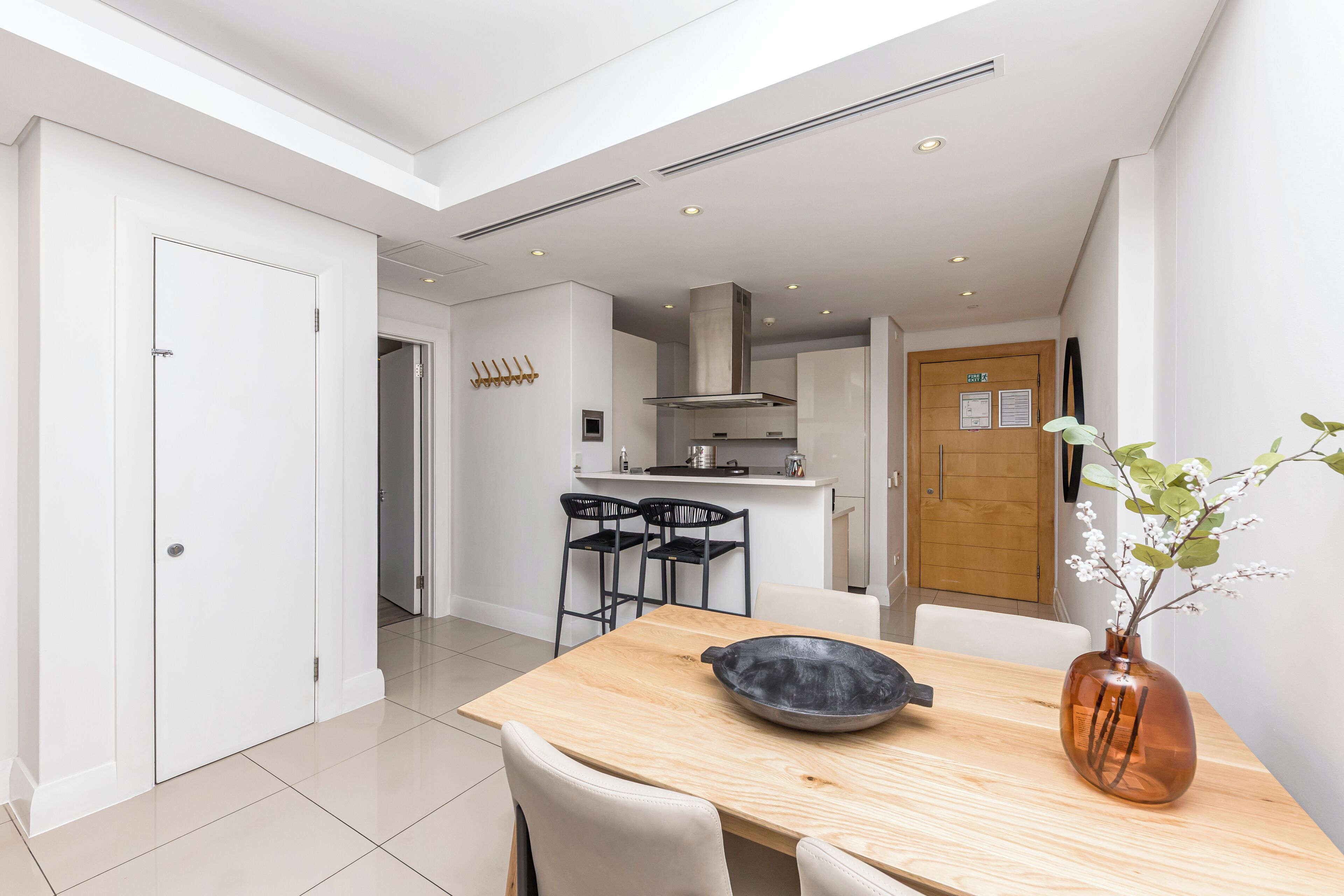 A modern kitchen with a dining area.
