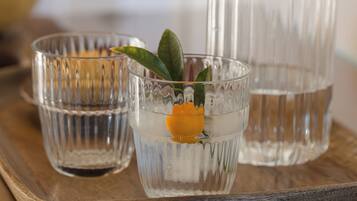 Trois récipients en verre contenant de l’eau et une tranche de citron, posés sur un plateau en bois.