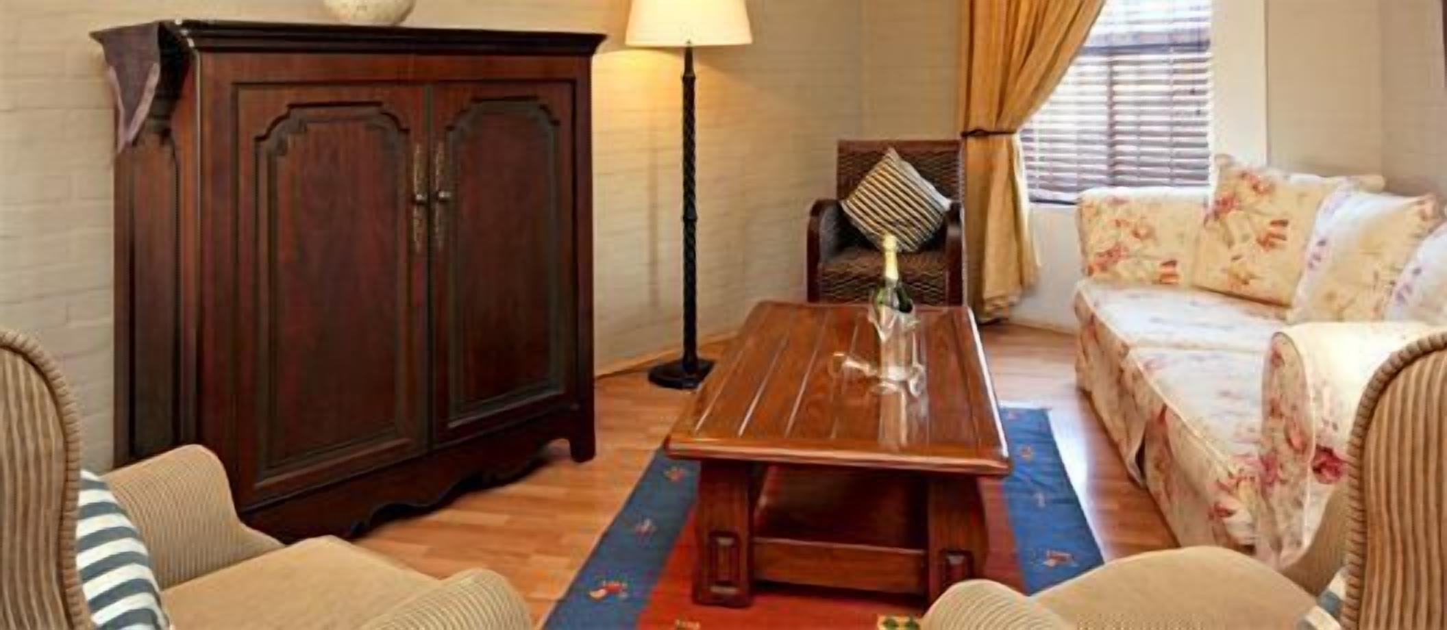A cozy living room with a wooden coffee table, a sofa, and a cabinet.
