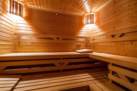 A sauna with wooden benches and slatted floors.
