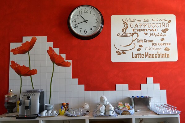 A coffee shop counter with a clock, coffee-making equipment, and a menu board listing various coffee types.