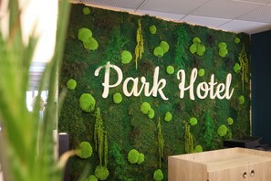 A wall with the text 'Park Hotel' and a wooden desk.