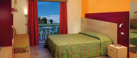 A hotel room with a bed, a small bedside table, a chair, a window with curtains, and a view of the outside.