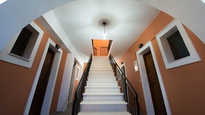 A staircase with white steps and black railings, leading to a door at the top. - Katerina (Zakynthos)