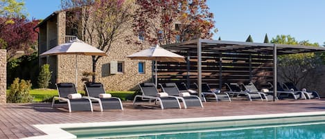Seasonal outdoor pool, open 8:00 AM to 9:00 PM, pool umbrellas