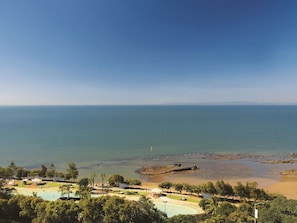 A coastal resort with a swimming pool, beach, and clear views of the sea.