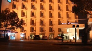 A multi-story hotel with balconies, a pharmacy, and a visible sign for JINJIANG INN. - Jinjiang Inn East Shanghai New International Exhibition Ctr (Shanghai)