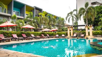 Een buitenzwembad, parasols voor strand/zwembad