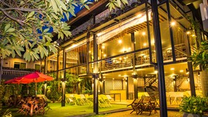A two-story building with outdoor seating and a staircase.