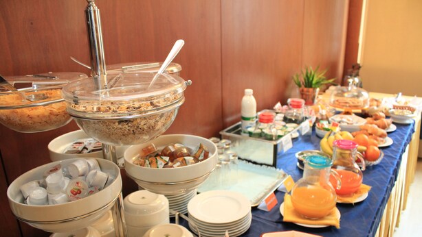 A buffet with various food items and utensils.