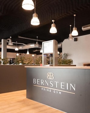 A gym reception area with a sign reading 'BERNSTEIN PRIME GYM'.