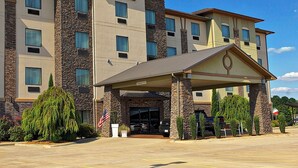 A Holiday Inn Express hotel with a stone facade, multiple windows, and a covered entrance. - Holiday Inn Express Heber Springs by IHG (Heber Springs)