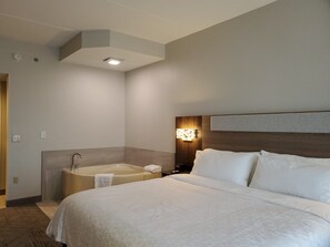 Suite, 1 King Bed, Jetted Tub | Desk, laptop workspace, blackout drapes, iron/ironing board