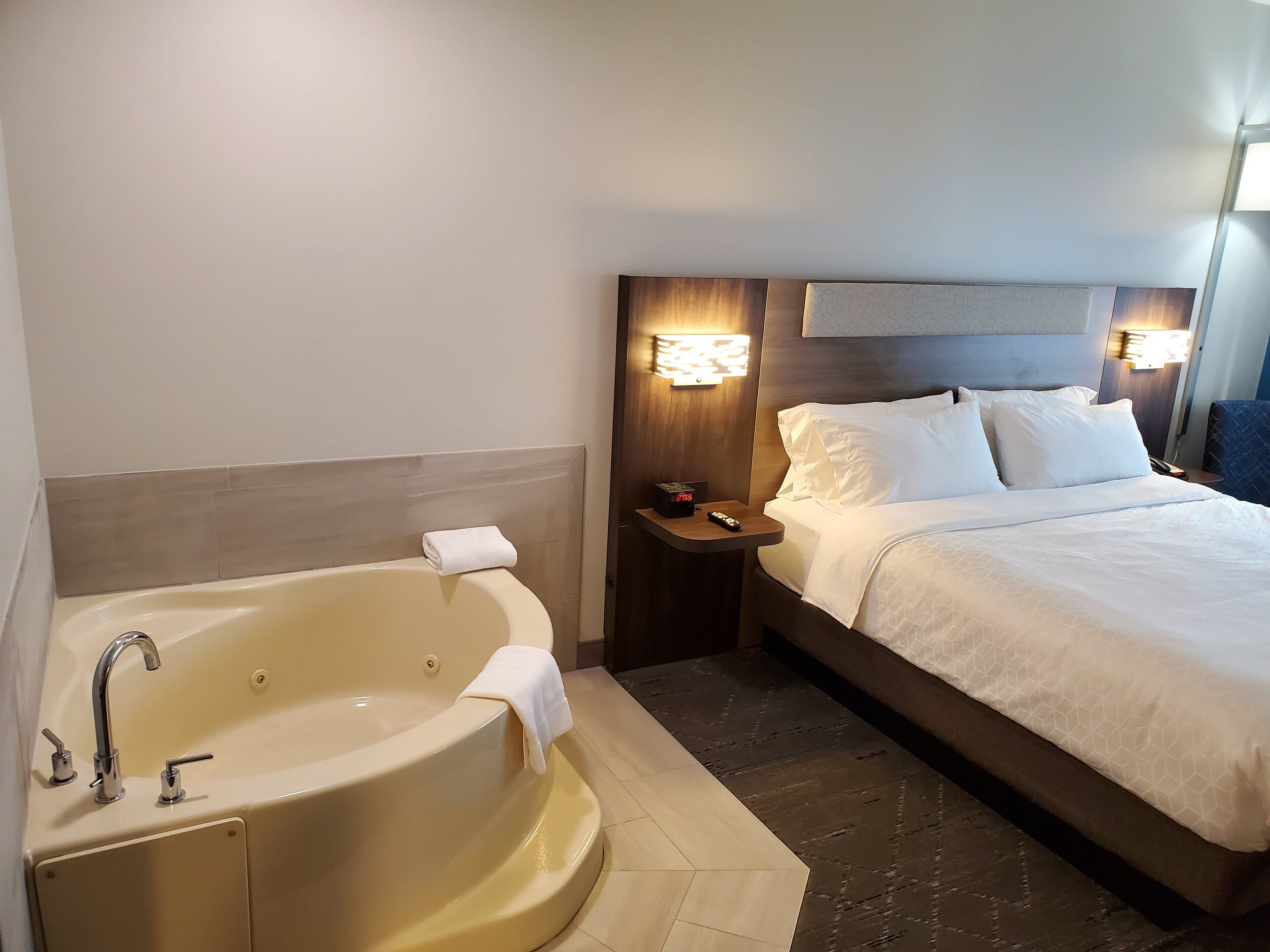 suite, 1 king bed, jetted tub | desk, laptop workspace, blackout curtains, iron/ironing board